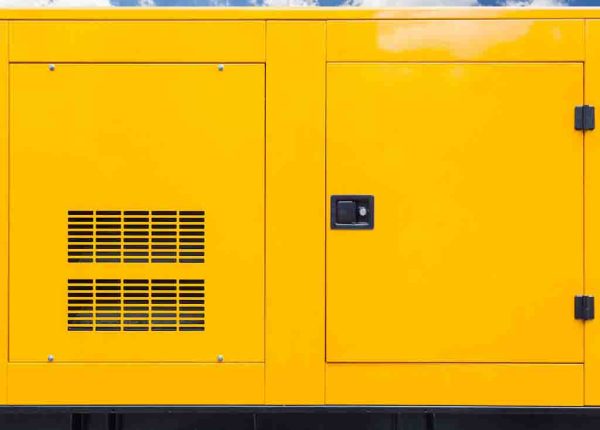 Big yellow mobile diesel box of autonomous generator for emergency electric power stand outside with blue cloud sky